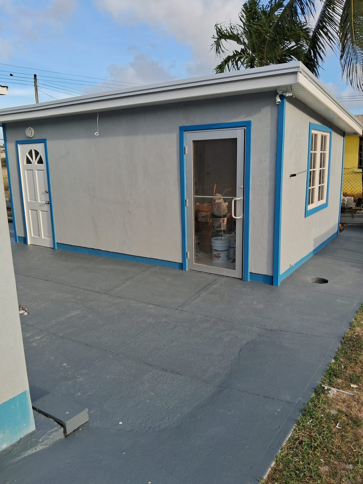 Freshly painted grey exterior with bright blue trim by MAJ Professional Painting Services