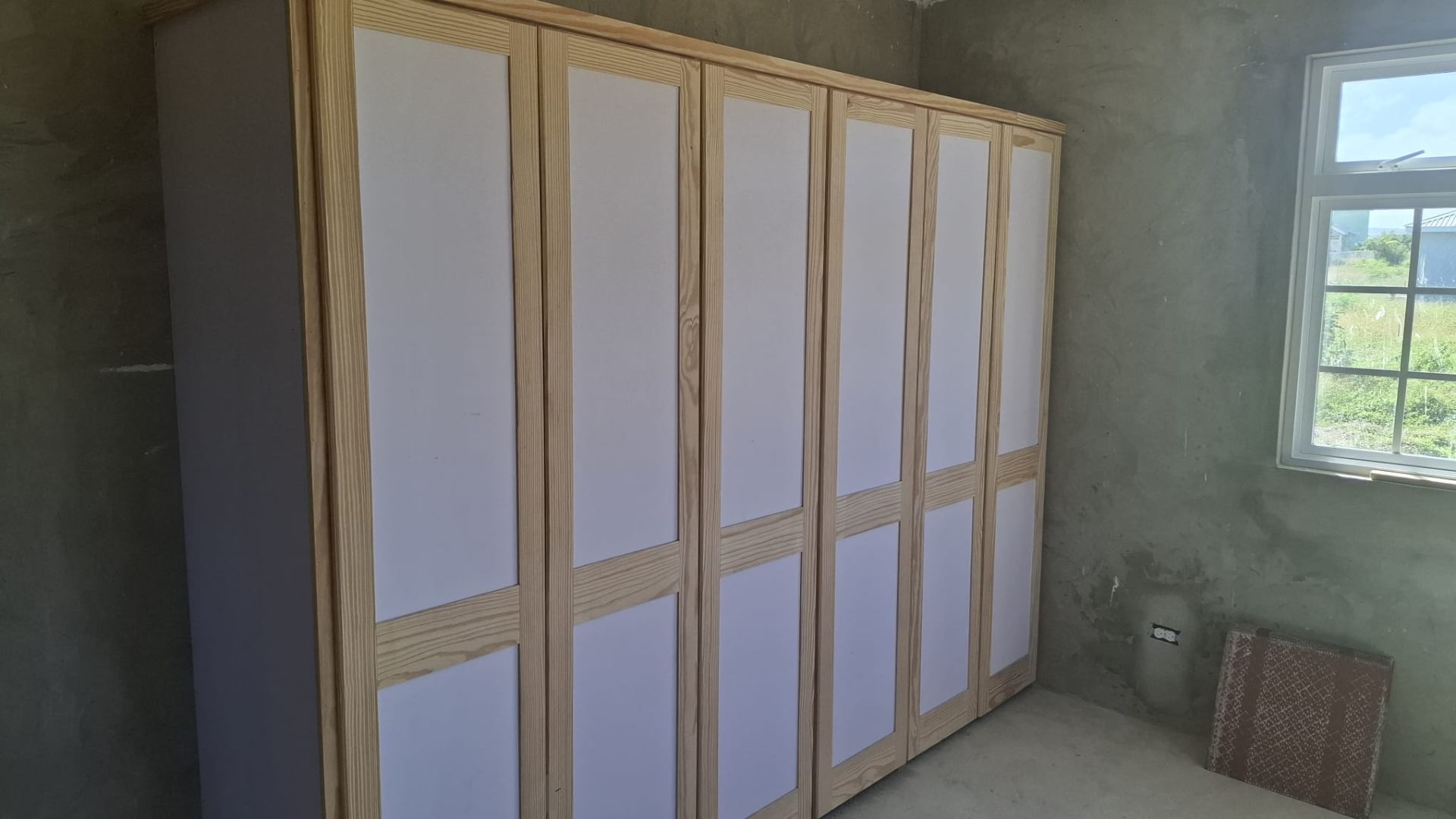 Custom built-in wardrobe with pine trim and white panels built by MAJ Professional Painting Services